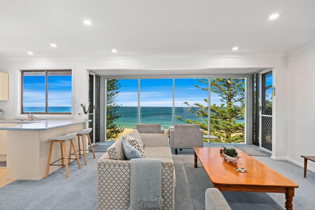 een keuken en woonkamer met uitzicht op de oceaan bij Forresters Dunes - Downstairs in Wamberal