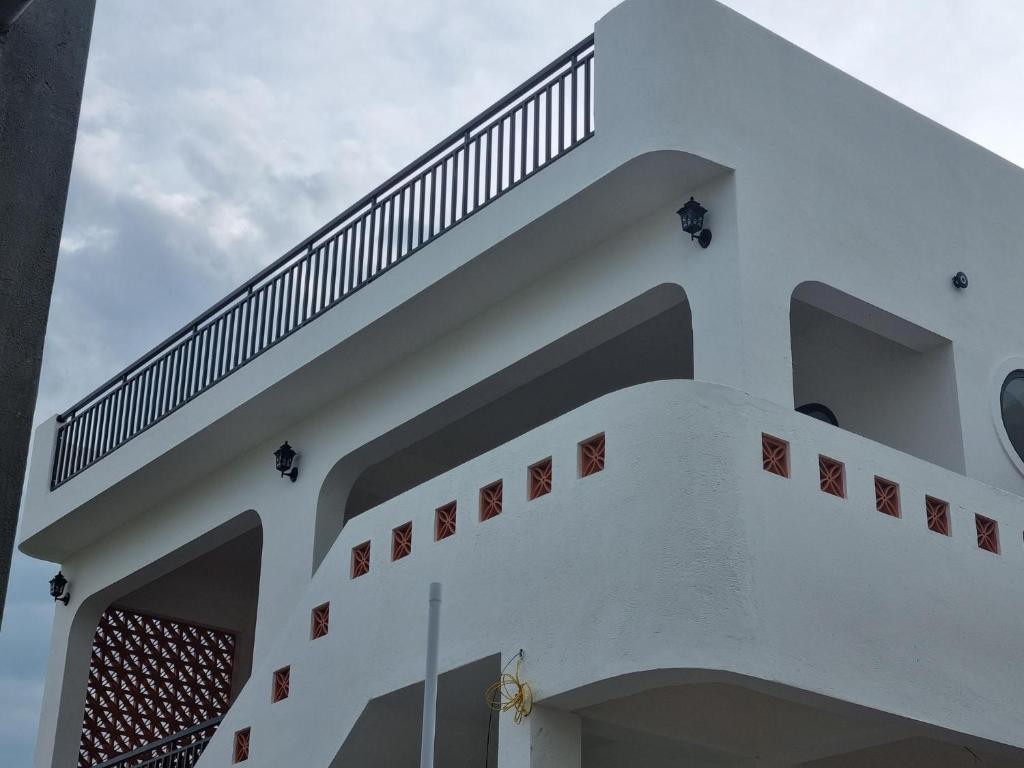 a white building with a staircase on top of it at The Vista My Hoa in Ninh Hải