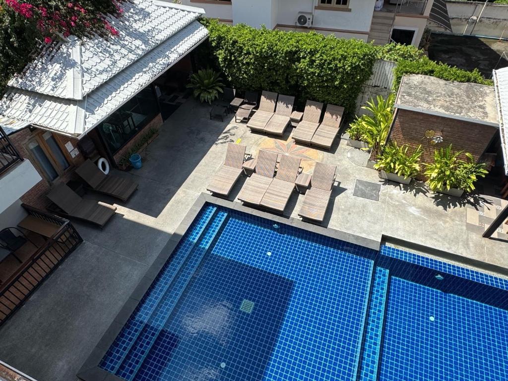 An overhead view shows two blue-tiled pool sections and a crowded sun deck.