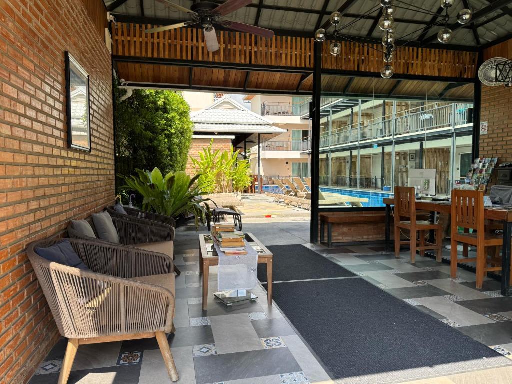 A covered seating and coffee area opens onto the pool courtyard.