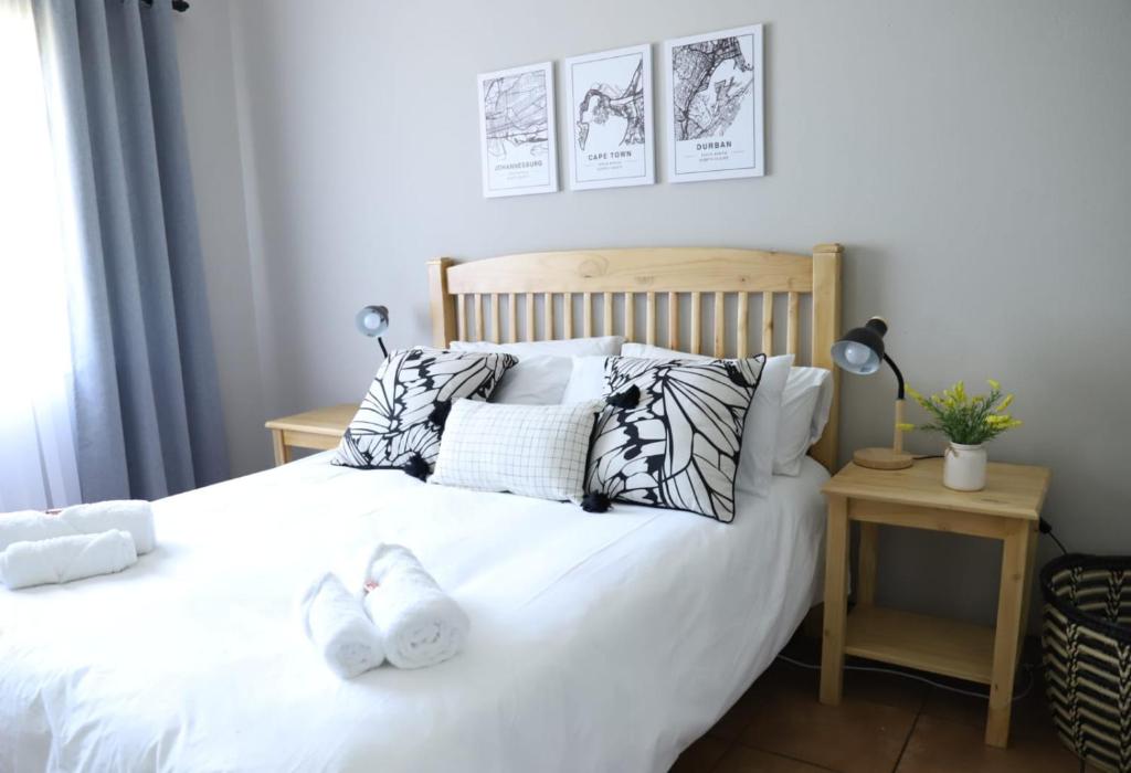 a bedroom with a bed with white sheets and pillows at Sleep-A-Lot in Piet Retief