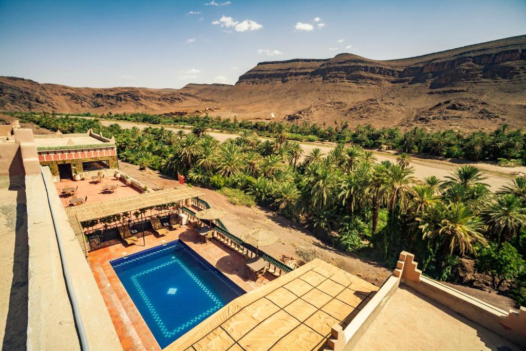 an aerial view of a resort with a swimming pool and mountains at La Terrasse des Delices in Ouarzazate