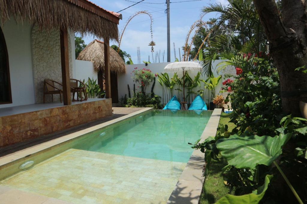 a swimming pool in a villa with a resort at Momy Breeze Uluwatu in Bingin Beach