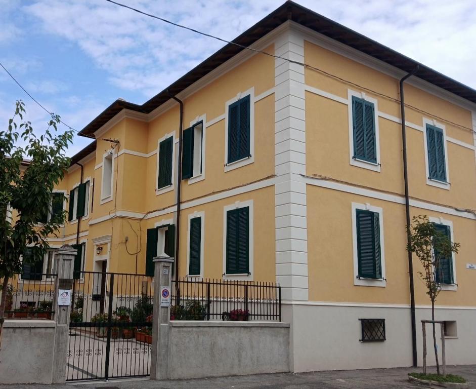 a yellow house with a fence in front of it at Marruvium 1937's in Avezzano
