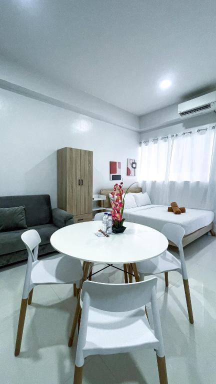 a living room with a table and chairs and a couch at WV 32 Urban Scenic Studio in Sampong