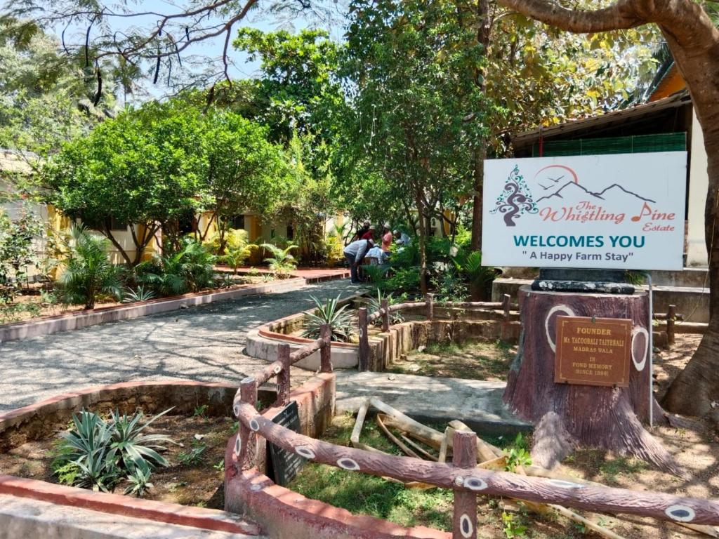 a sign for the wildlife park welcomes you at The Whistling Pine Woods in Varagampadi