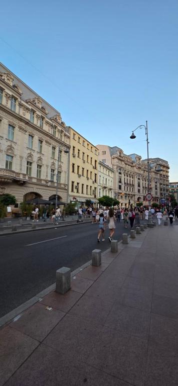 a city street with people running down the street at Victoriei54YOU in Bucharest