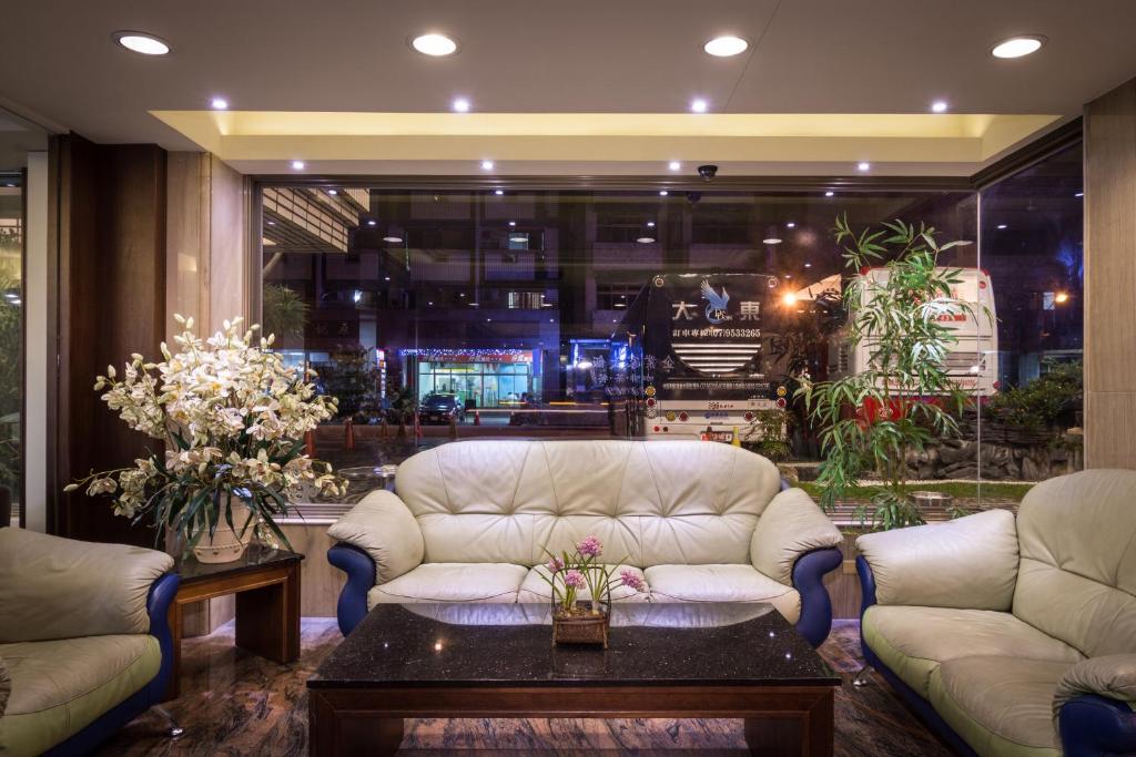 a living room with two couches and a coffee table at The Enterpriser Hotel in Taichung