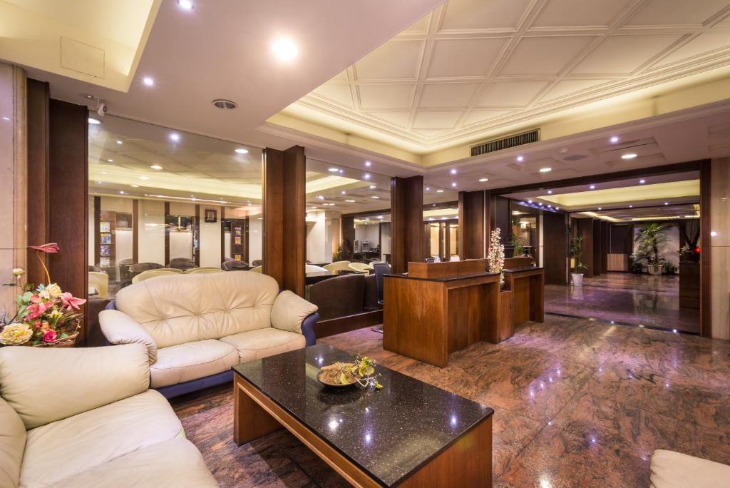 a lobby with couches and a table in a building at The Enterpriser Hotel in Taichung
