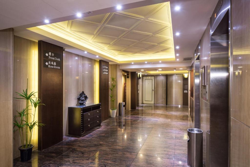 a lobby of a building with a hallway with a ceiling at The Enterpriser Hotel in Taichung