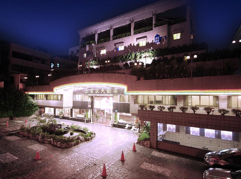 a building with a courtyard in front of it at night at The Enterpriser Hotel in Taichung