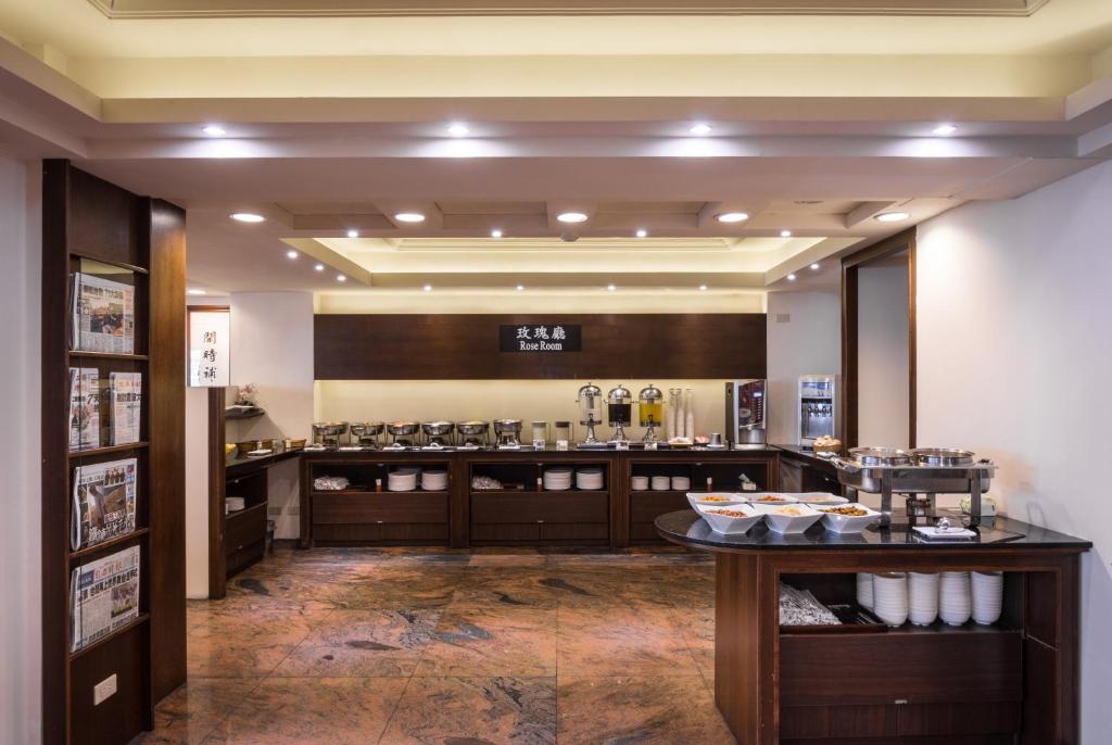 a restaurant with a counter with food on display at The Enterpriser Hotel in Taichung