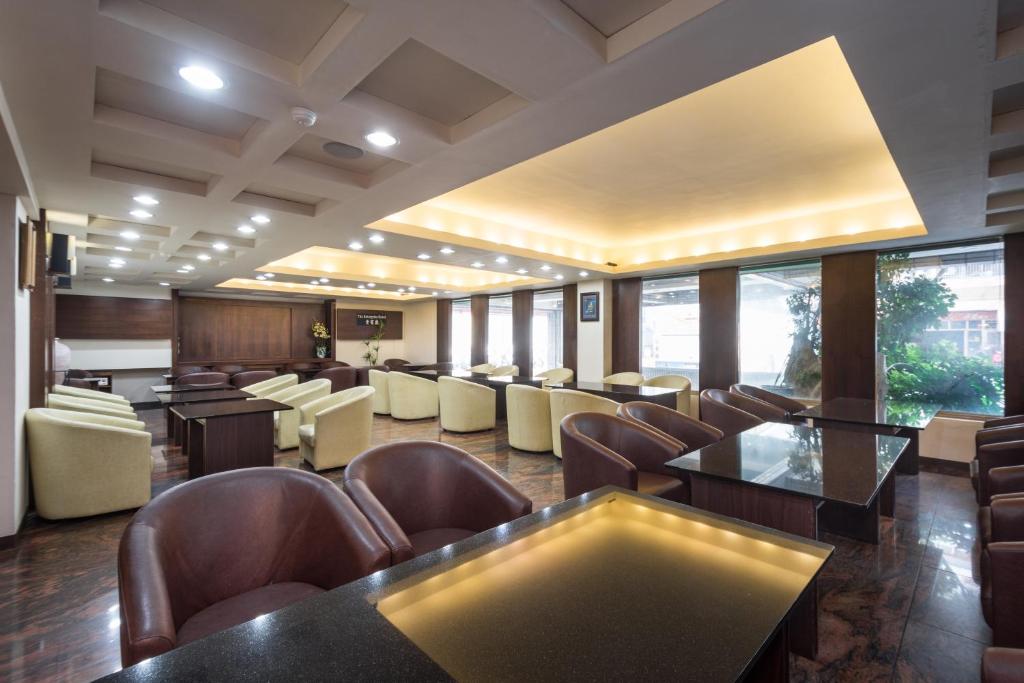 a conference room with chairs and tables and windows at The Enterpriser Hotel in Taichung