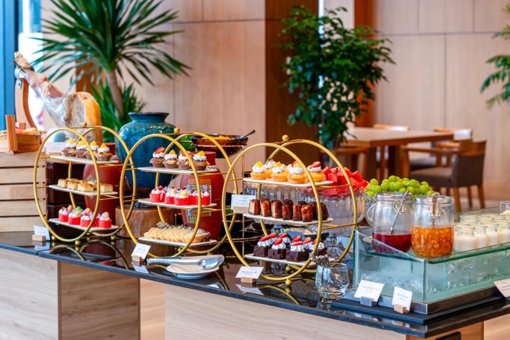 A dessert and drinks display arranged on gold-framed stands in the dining room.