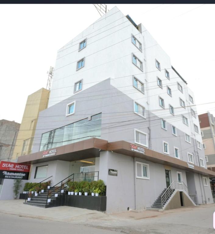 a tall white building with stairs in front of it at Stae Hotel-Gachibowli in Hyderabad