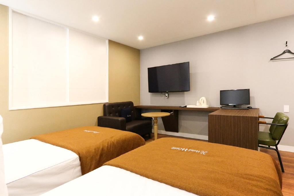 Postel nebo postele na pokoji v ubytování Hotel Home