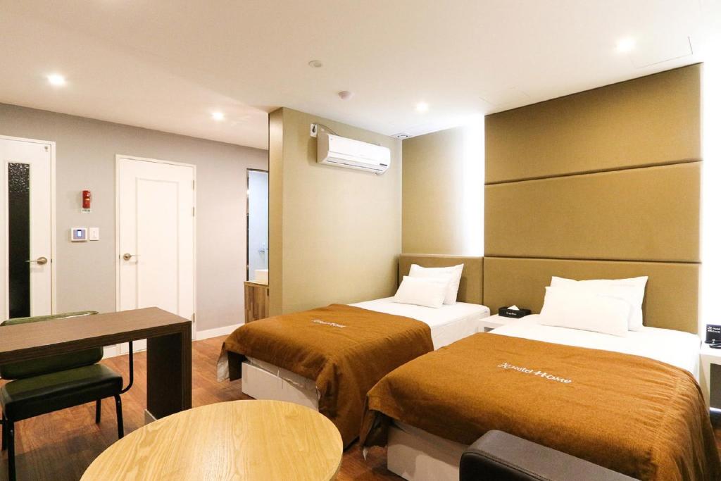Postel nebo postele na pokoji v ubytování Hotel Home