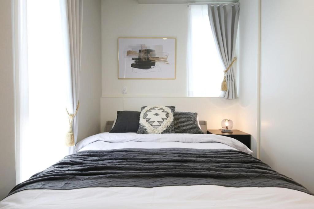 Postel nebo postele na pokoji v ubytování インテグラル大手町 203