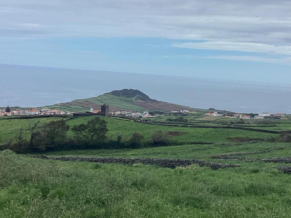 a green field with a mountain in the background at Casa das Cales - Grande in Altares