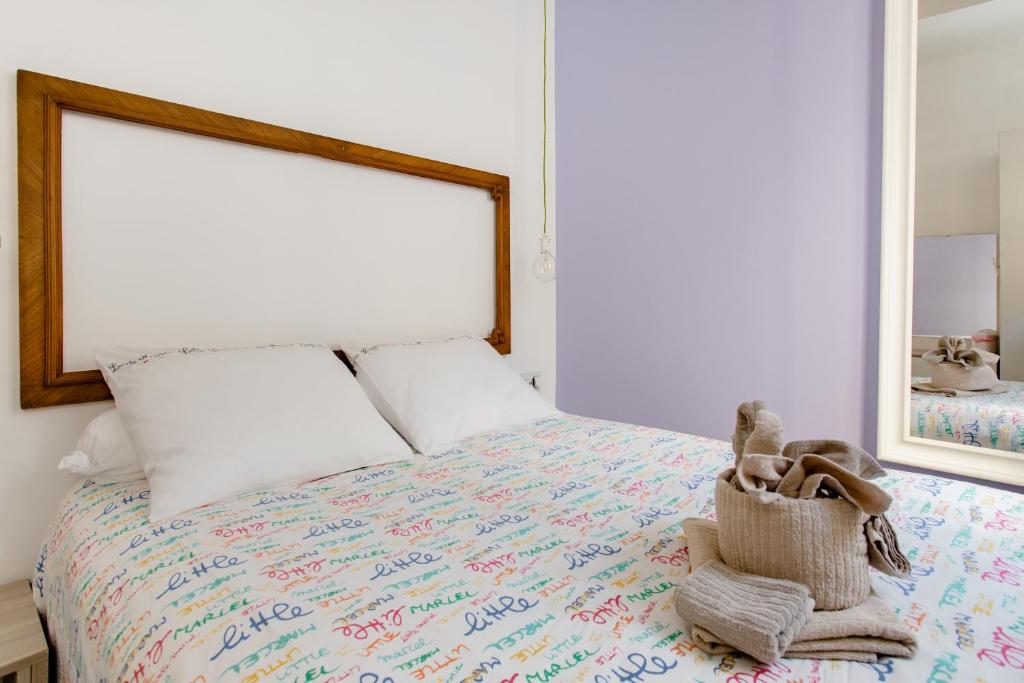 a bedroom with a bed with a bag on it at Nemy Sliema Guesthouse in Sliema