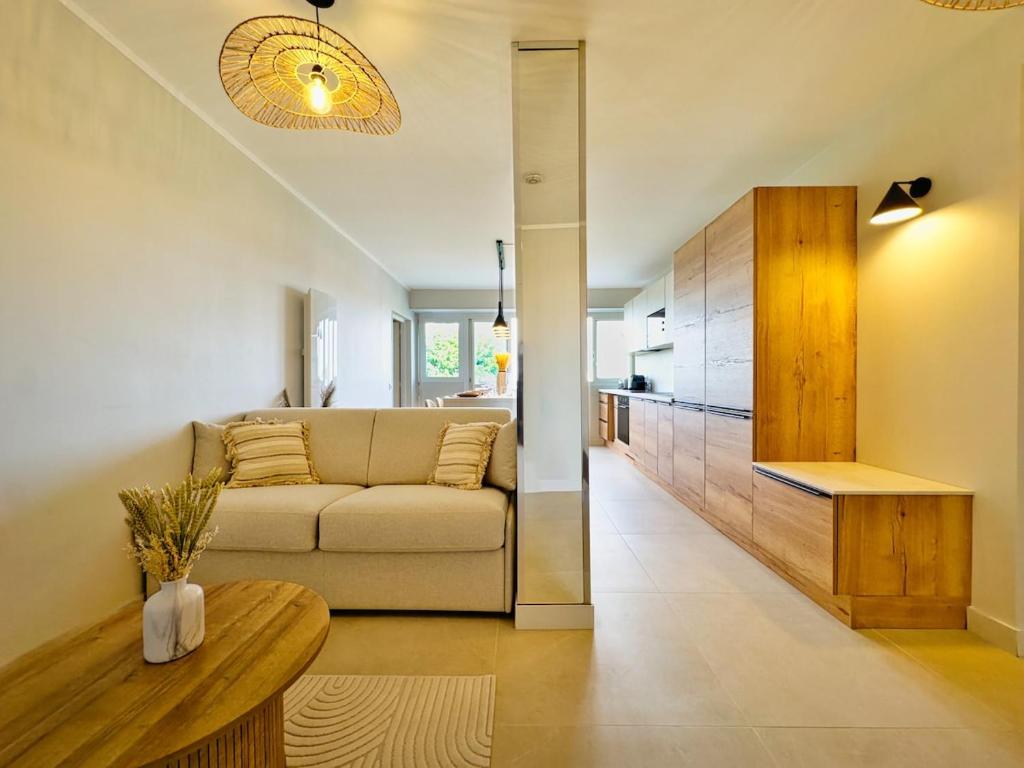 a living room with a couch and a table at Escapade Rochelaise in La Rochelle