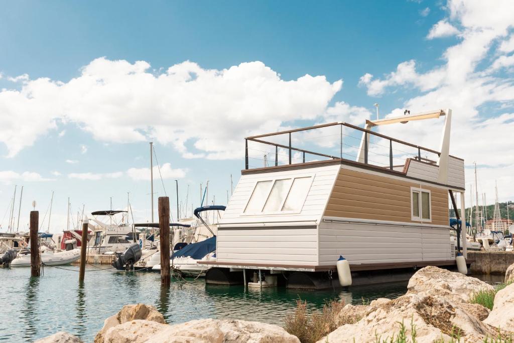 a small boat is docked at a marina at Floating House Marina in Portorož