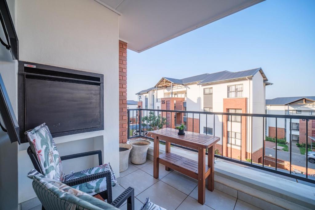 a balcony with a table and a view of a building at 366 Ballito Hills in Ballito