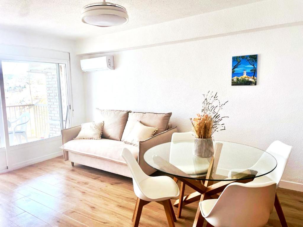 a living room with a table and a couch at Isla de los Pensamientos in Faro de Cullera