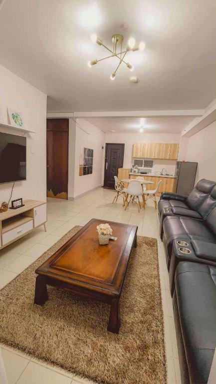 a living room with a couch and a coffee table at Comfy Condo Mactan Cebu in Sampong