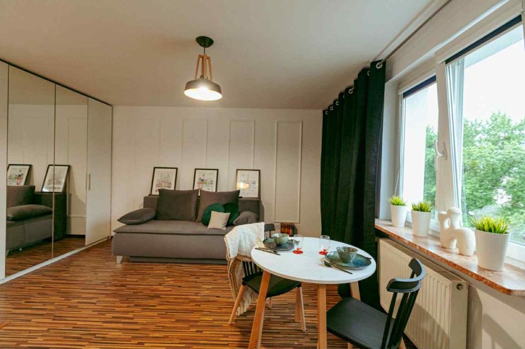 a living room with a table and a couch at City Vibes Warsaw Sienna by P&M in Warsaw