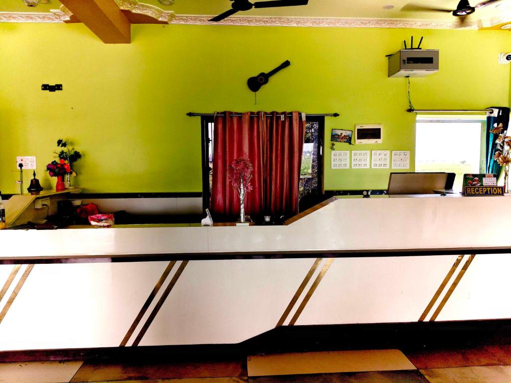 a ping pong table in a room with green walls at Hotel O AM2PM Restaurant 