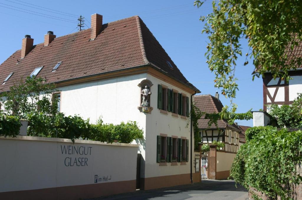 a white building with a brown roof at Bioweingut Glaser in Hainfeld