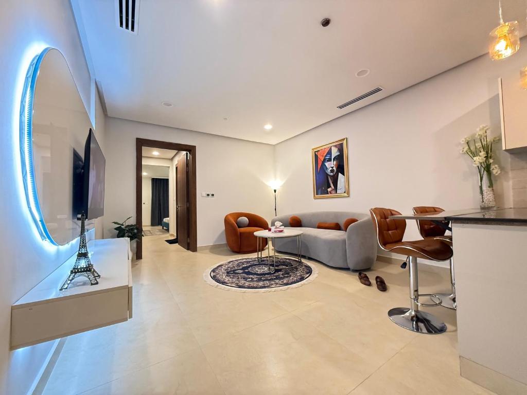 a living room with a couch and a tv at Serviced Apartments-Mall of Islamabad-F7 in Islamabad