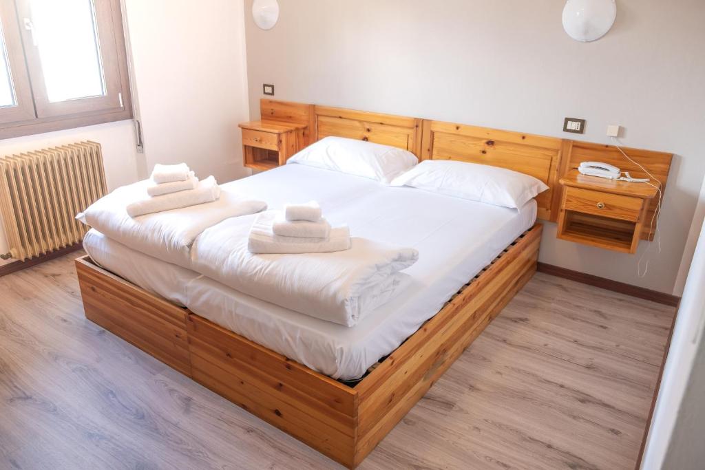 a bedroom with a large bed with towels on it at Hotel ristorante San Marco 