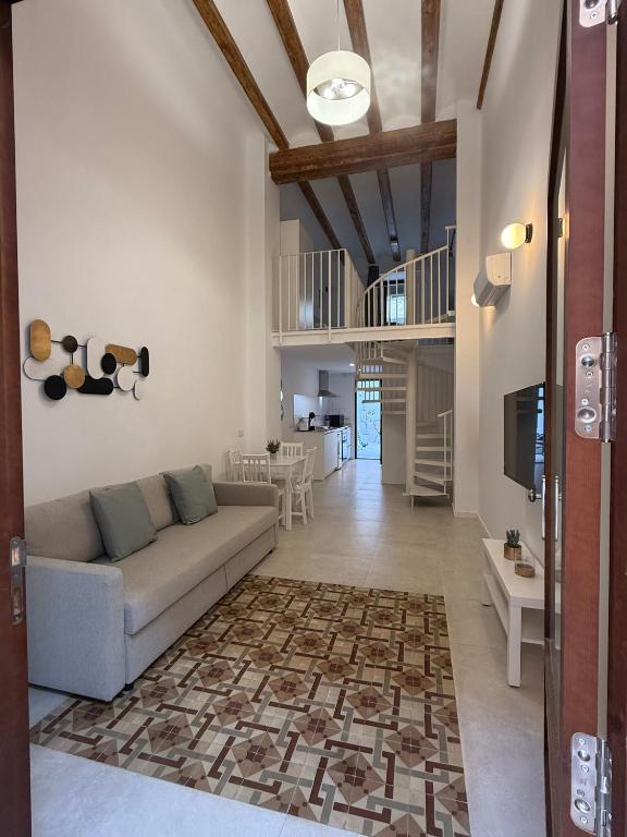 a living room with a couch and a tv at K&A Apartments in Valencia