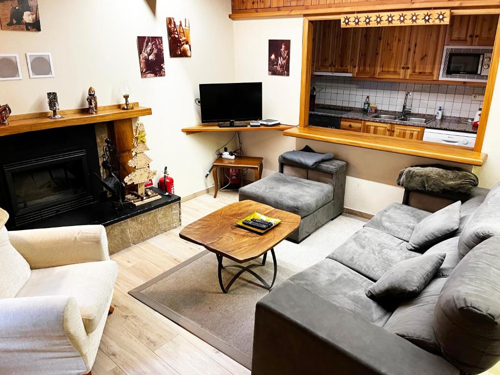 een woonkamer met een bank en een tafel bij SNÖ Casa Pucurull in Salardú