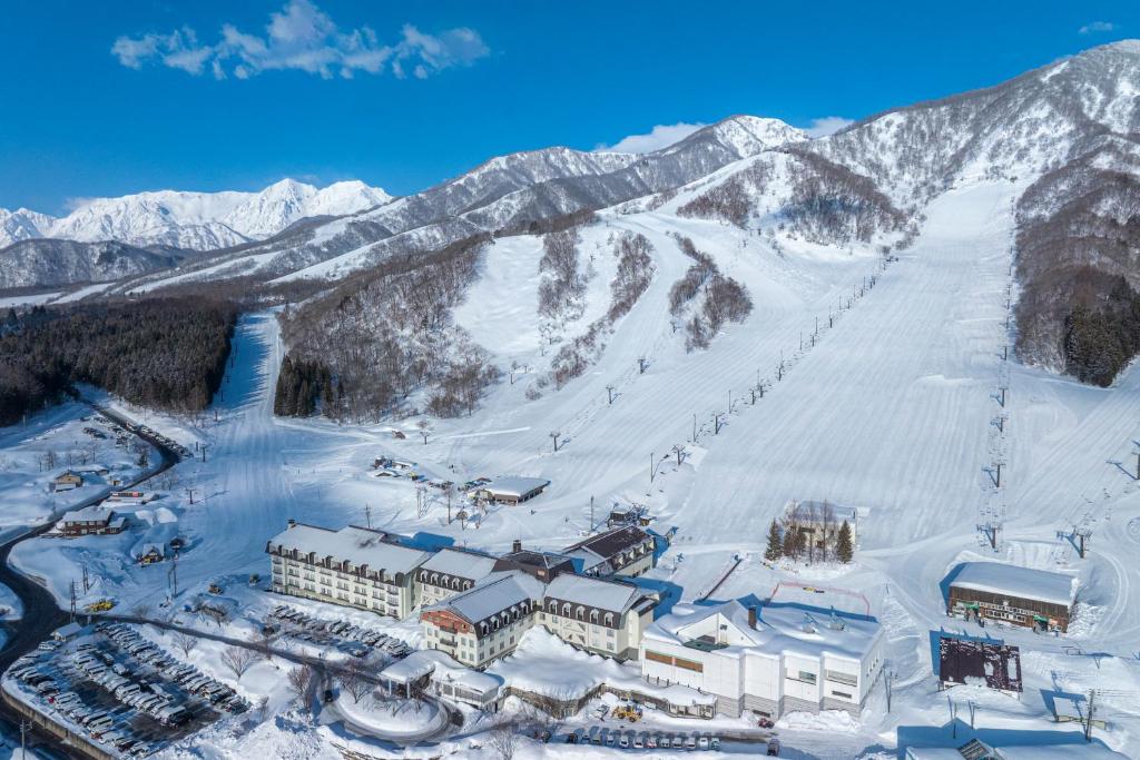 an aerial view of a ski resort in the snow at The Alps Hotel Hakuba in Otari
