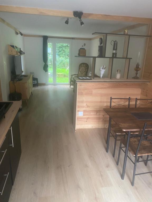 a living room with a wooden table and chairs at Chez Nico in Frans