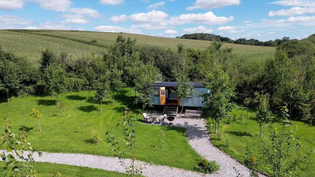a house in the middle of a field at Da Vinci's Den in North Tawton