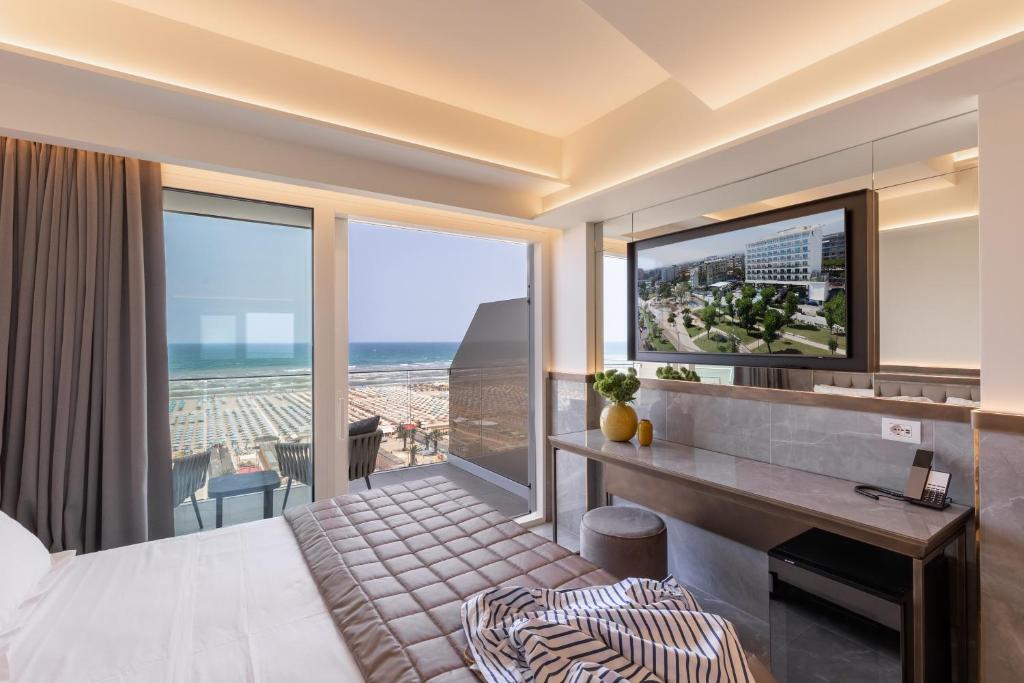 a bedroom with a view of the ocean at Hotel Sporting in Rimini