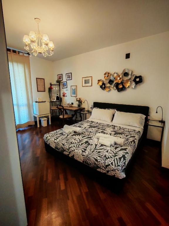 a bedroom with a bed and a chandelier at Leonardo Rome Holidays in Fiumicino