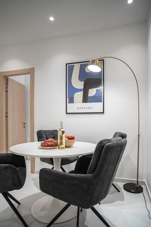 a dining room with a white table and chairs at Koukaki Urban Suites in Athens