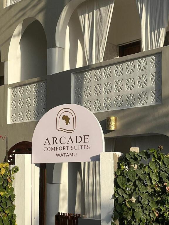 a sign for an arabic contractorccessccessccessived at watamu New Arcade Comfort Suite in Watamu