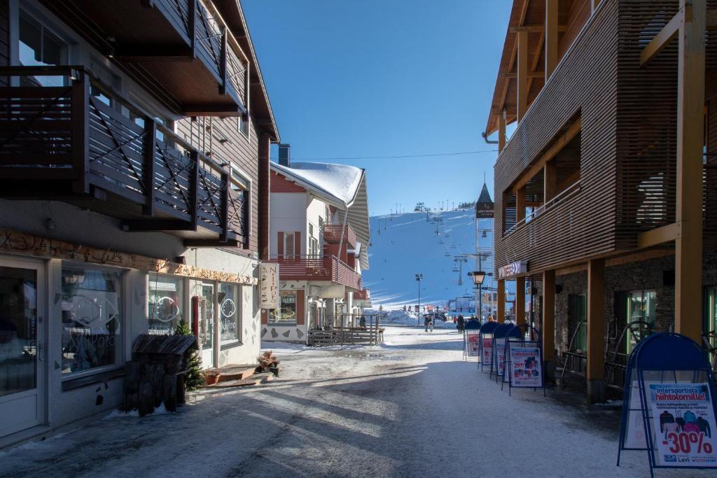 an empty street in a town with buildings at Ski Center Alpine Houses A6 in Levi
