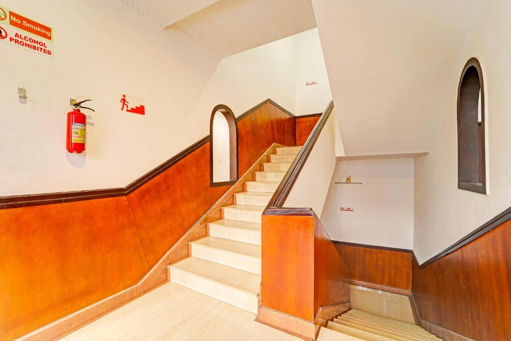 a staircase in a church with a fire hydrant on the wall at Hotel O Padma Junction MG Road in Cochin