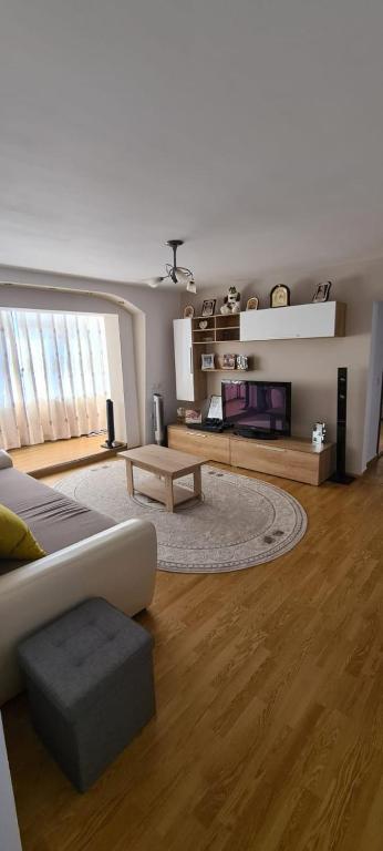 a living room with a couch and a table at Apartament in Rădăuţi