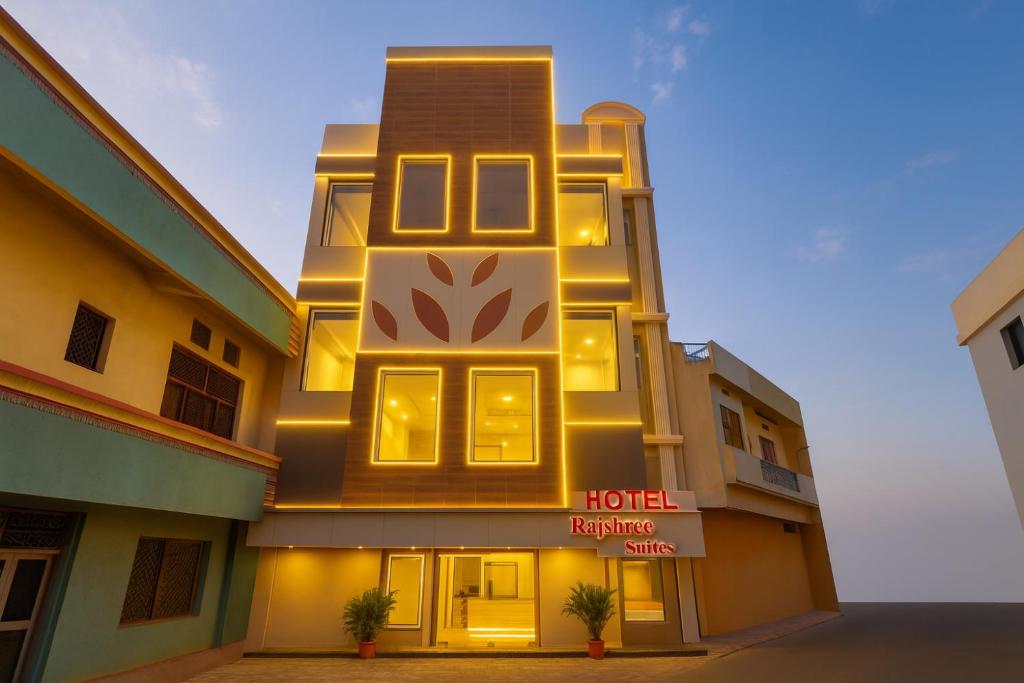 a hotel building with a sign on the side of it at Hotel Rajshree Suites in Ujjain