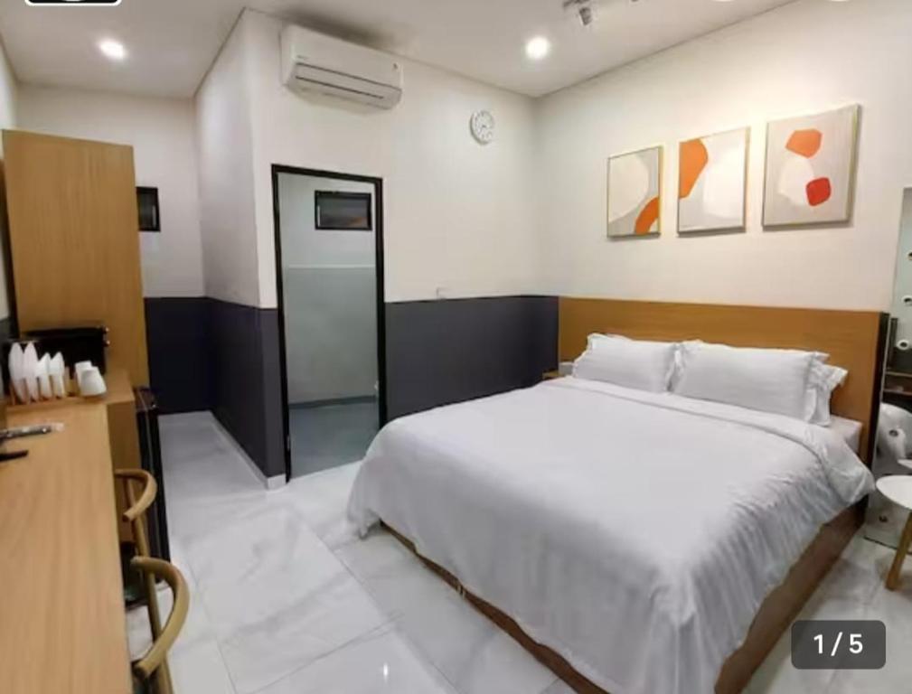 a bedroom with a large white bed in a room at The W Residence in Jakarta