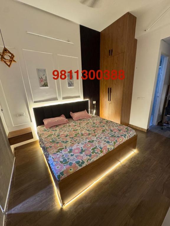 a bedroom with a large bed with a night light at Heavenly stays in Greater Noida