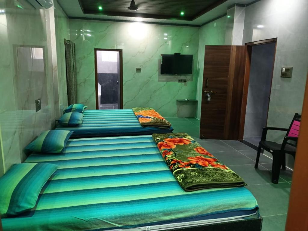 a large bed in a room with a tv at Samruddhi Groups in Mādhavaram